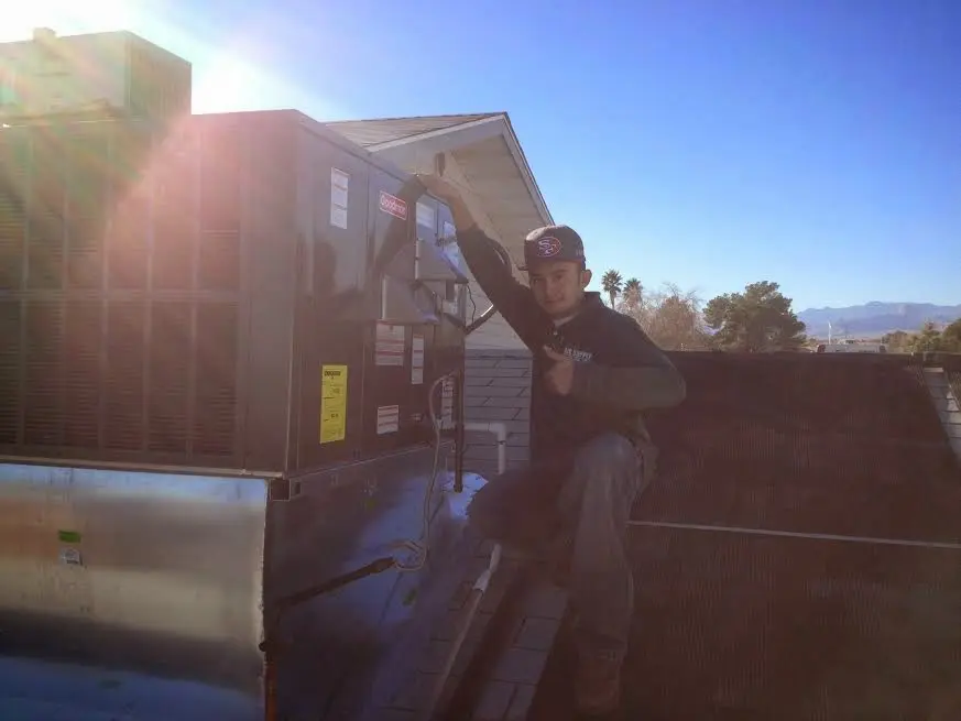 HVAC technician performing Air Duct Repair on a rooftop unit in Rosendale